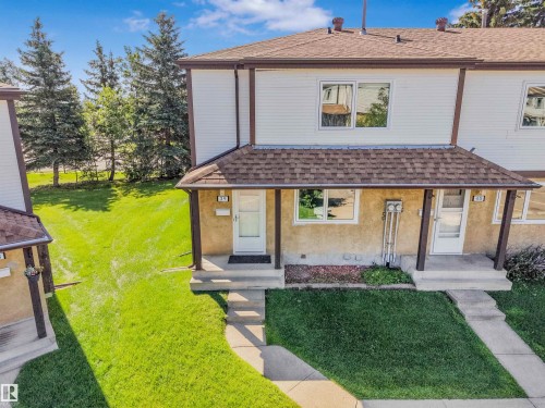 Two-story multi-unit structure featuring brown shingle roofing and white siding - #39 14511 52 Street Nw, Edmonton, AB - Outdoor