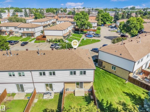Rear exterior of a townhouse featuring a private fenced yard and sliding patio doors - #39 14511 52 Street Nw, Edmonton, AB - Outdoor