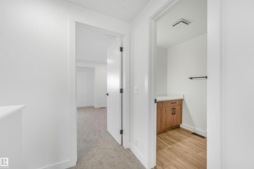 Interior hallway featuring light grey carpeting, white walls, and a white trim - #39 14511 52 Street Nw, Edmonton, AB - Indoor Photo Showing Other Room