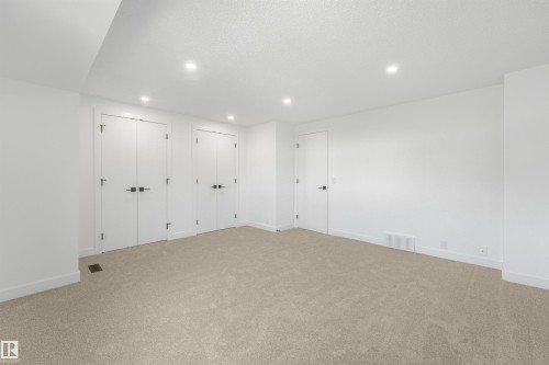 Carpeted room featuring white walls and a white ceiling with recessed lighting - #39 14511 52 Street Nw, Edmonton, AB - Indoor Photo Showing Other Room