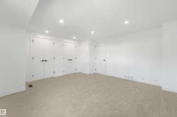 Carpeted room featuring white walls and a white ceiling with recessed lighting - 