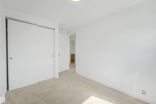 Carpeted interior space featuring white walls and a white ceiling with a flush-mount light fixture - #39 14511 52 Street Nw, Edmonton, AB - Indoor Photo Showing Other Room