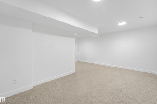 Expansive room with neutral carpeting and recessed lighting - #39 14511 52 Street Nw, Edmonton, AB - Indoor Photo Showing Other Room