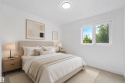 White wall finishes, recessed lighting, double-paned window, and light-toned carpeting - 