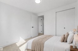 Plush carpet flooring, white walls, flush-mount ceiling light fixture, and white bi-fold closet doors - 