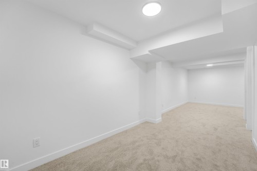 Spacious room featuring neutral carpet flooring, white walls, and recessed lighting fixtures - #39 14511 52 Street Nw, Edmonton, AB - Indoor
