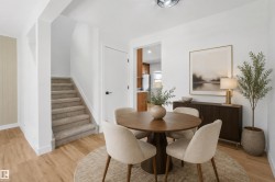 Carpeted staircase, wood-finish flooring, white walls, and a recessed ceiling light fixture - 
