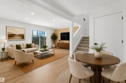 Open-concept living space featuring wood-finish flooring, recessed lighting, and sliding glass doors - 