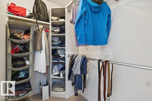 Built-in closet system featuring multiple shelving units, hanging rods, and corner storage - 1046 Jones Crescent Nw, Edmonton, AB - Indoor With Storage