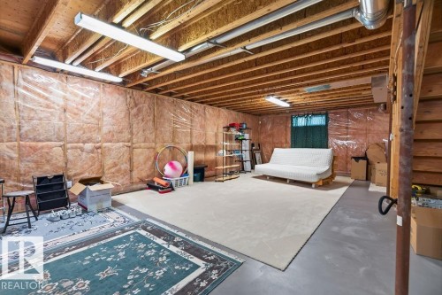 Unfinished lower level with exposed ceiling joists, insulated walls, and concrete flooring - 1046 Jones Crescent Nw, Edmonton, AB - Indoor Photo Showing Basement