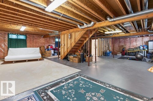 Open basement space featuring exposed wood joists, concrete flooring, and visible ductwork - 1046 Jones Crescent Nw, Edmonton, AB - Indoor Photo Showing Basement