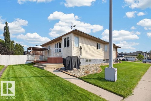 Rear exterior featuring beige siding and a walk-out basement - 1046 Jones Crescent Nw, Edmonton, AB - Outdoor