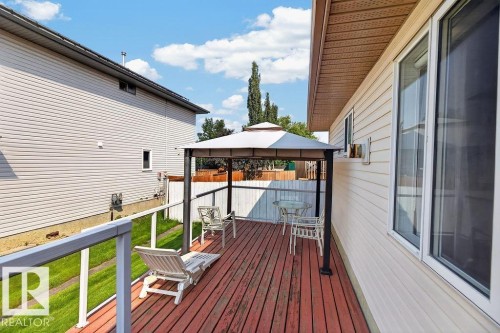 Expansive rear deck featuring a gazebo, wood-finish decking, and contemporary glass panel railing - 1046 Jones Crescent Nw, Edmonton, AB - Outdoor With Deck Patio Veranda With Exterior