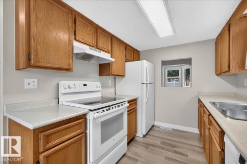 #23 10453 20 Av Nw, Edmonton, AB - Indoor Photo Showing Kitchen With Double Sink