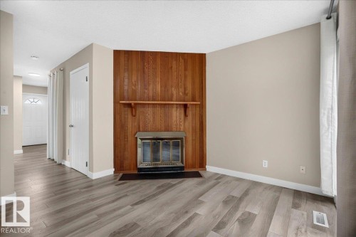 #23 10453 20 Av Nw, Edmonton, AB - Indoor Photo Showing Living Room With Fireplace
