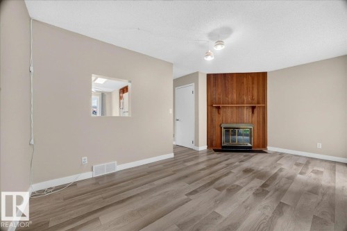 #23 10453 20 Av Nw, Edmonton, AB - Indoor Photo Showing Living Room With Fireplace
