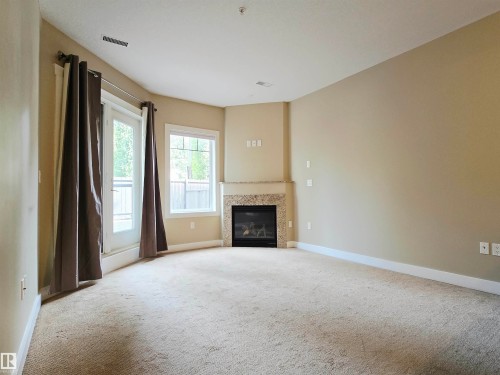 #21 11518 76 Av Nw, Edmonton, AB - Indoor Photo Showing Living Room With Fireplace