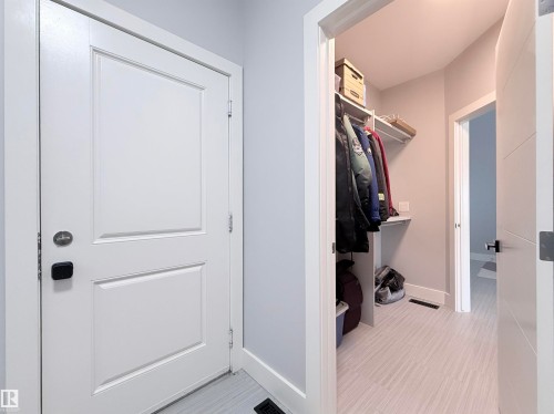 Entryway featuring a white paneled door with contemporary hardware - 8719 218 Street Nw, Edmonton, AB - Indoor