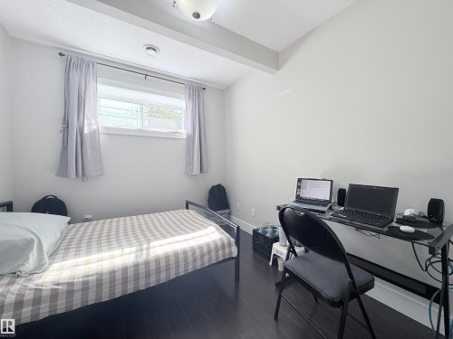 Room featuring dark wood-finish flooring and light-toned walls - 8719 218 Street Nw, Edmonton, AB - Indoor