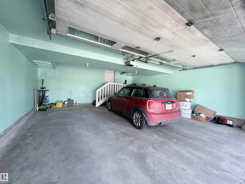 Spacious garage featuring concrete flooring and light-colored walls - 8719 218 Street Nw, Edmonton, AB - Indoor Photo Showing Garage