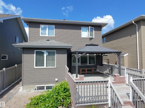 Spacious rear deck featuring a dark grey gazebo, white window frames, and grey horizontal siding - 8719 218 Street Nw, Edmonton, AB - Outdoor With Deck Patio Veranda With Exterior