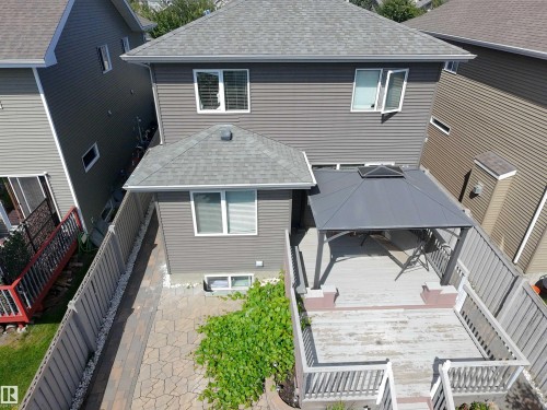 Rear exterior featuring gray horizontal siding and a multi-level wood deck - 8719 218 Street Nw, Edmonton, AB - Outdoor