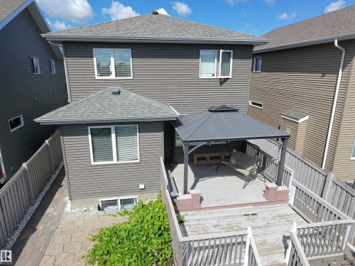 Rear exterior featuring grey horizontal siding and a multi-level wooden deck - 8719 218 Street Nw, Edmonton, AB - Outdoor With Exterior