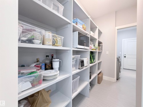 Walk-in pantry featuring extensive white shelving - 8719 218 Street Nw, Edmonton, AB - Indoor