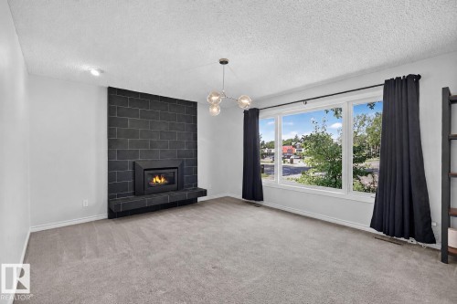 7707 156 Street Nw, Edmonton, AB - Indoor Photo Showing Living Room With Fireplace