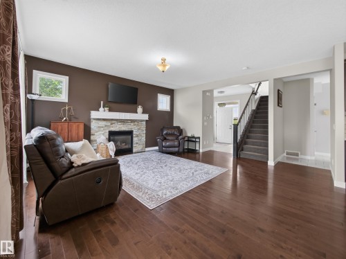 5718 42 Street, Beaumont, AB - Indoor Photo Showing Living Room With Fireplace