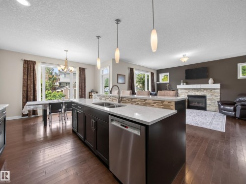 5718 42 Street, Beaumont, AB - Indoor Photo Showing Kitchen With Fireplace With Double Sink With Upgraded Kitchen