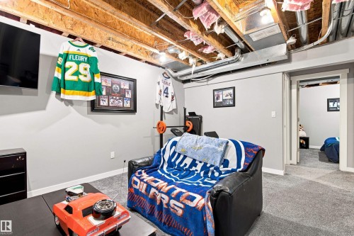 Finished wall surfaces, installed carpeting, recessed lighting, and exposed ceiling joists - 204 59 Street Sw, Edmonton, AB - Indoor Photo Showing Basement