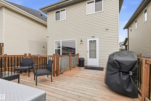 Expansive composite deck featuring warm wood-finish decking, wooden railings, and integrated seating areas - 204 59 Street Sw, Edmonton, AB - Outdoor With Deck Patio Veranda With Exterior
