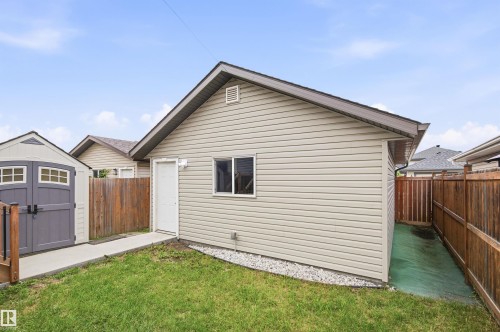 Spacious single-story residence featuring cream-colored vinyl siding, a gabled roofline, and a covered entry - 204 59 Street Sw, Edmonton, AB - Outdoor With Exterior
