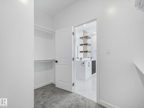 Walk-in closet with built-in shelving and carpet flooring - 239 Kinglet Boulevard Nw, Edmonton, AB - Indoor