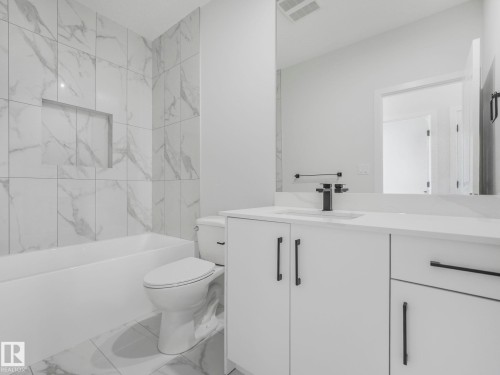 Bathroom featuring a white vanity with matte black hardware, a rectangular undermount sink, and a black faucet - 239 Kinglet Boulevard Nw, Edmonton, AB - Indoor Photo Showing Bathroom