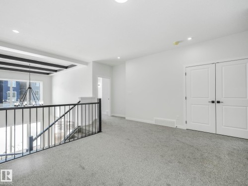 Loft area featuring grey carpeting, recessed lighting, and white walls - 239 Kinglet Boulevard Nw, Edmonton, AB - Indoor Photo Showing Other Room