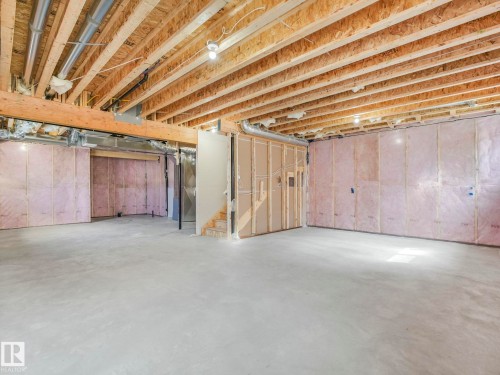 Spacious unfinished basement offering concrete flooring, exposed wood joists, framed walls, and insulation - 239 Kinglet Boulevard Nw, Edmonton, AB - Indoor Photo Showing Basement
