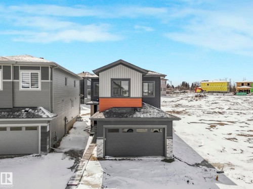 Contemporary two-story residence featuring a gray and white exterior with an orange accent panel - 239 Kinglet Boulevard Nw, Edmonton, AB - Outdoor