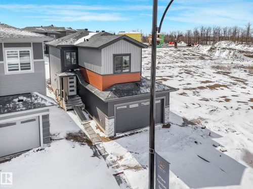 Modern two-story residence with a multi-toned exterior featuring grey siding and brown paneling - 239 Kinglet Boulevard Nw, Edmonton, AB - Outdoor