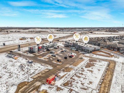 Aerial perspective showcasing two commercial buildings with multiple units, ample surface parking, and road frontage - 239 Kinglet Boulevard Nw, Edmonton, AB - Outdoor With View