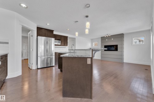 6156 11 Avenue Sw, Edmonton, AB - Indoor Photo Showing Kitchen With Fireplace