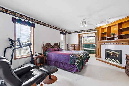 115 Aspen Ridge Crescent, Wetaskiwin, AB - Indoor Photo Showing Bedroom With Fireplace