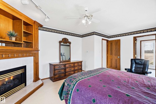 115 Aspen Ridge Crescent, Wetaskiwin, AB - Indoor Photo Showing Bedroom With Fireplace