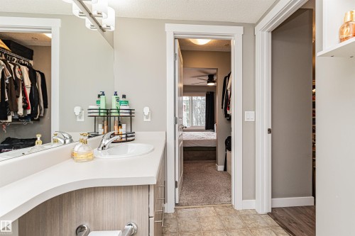 Vanity with a polished chrome faucet, under-sink cabinetry, and an oval sink basin - #310 2229 44 Av Nw, Edmonton, AB - Indoor Photo Showing Bathroom