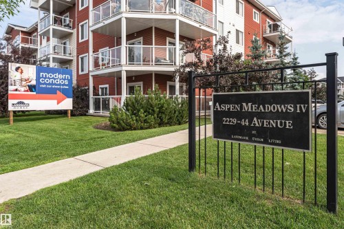Multi-story residential building featuring red siding and white trim - #310 2229 44 Av Nw, Edmonton, AB - Outdoor With Balcony