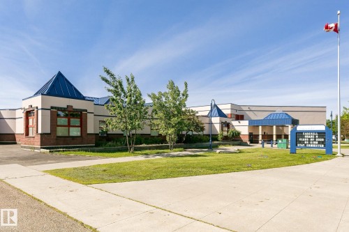 Distinctive commercial or institutional property featuring a modern architectural design with peaked roof accents and blue metal detailing - #310 2229 44 Av Nw, Edmonton, AB - Outdoor