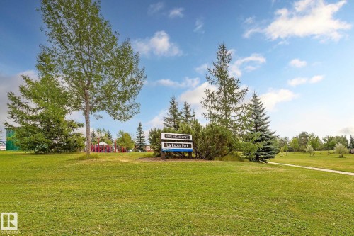 Expansive manicured lawn with mature shade trees and evergreen plantings - #310 2229 44 Av Nw, Edmonton, AB - Outdoor With View