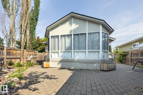 Modern residential structure featuring expansive multi-panel windows, peaked roofline with contemporary architectural detailing, and corrugated metal siding accents - 9503 54 Street Nw, Edmonton, AB - Outdoor With Exterior