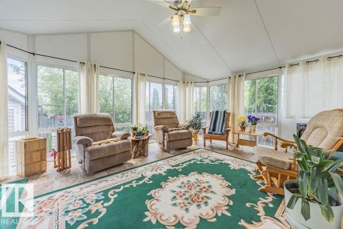 Sunroom with vaulted ceilings and a ceiling fan - 9503 54 Street Nw, Edmonton, AB - Indoor Photo Showing Living Room
